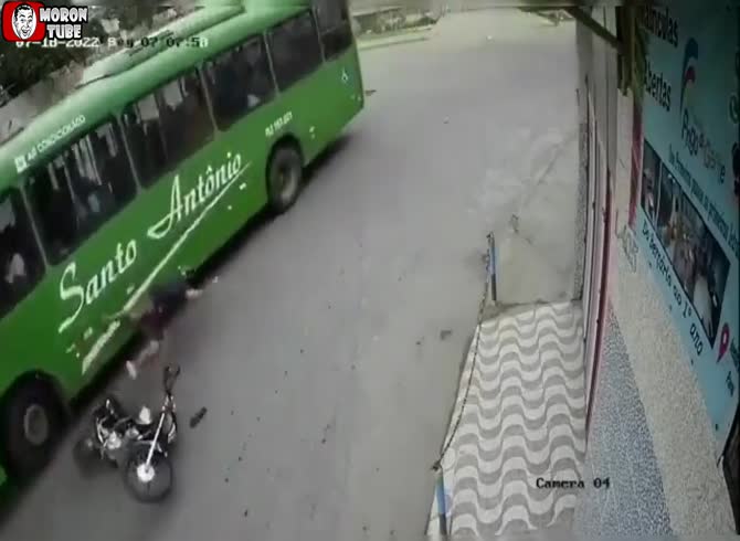 Video: A biker's helmet saves his life when he goes beneath a bus!